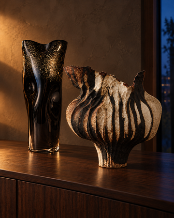 Umbra Drip and Noir Gilt vases on a dark walnut sideboard in warm evening light