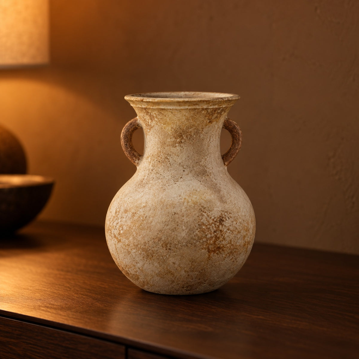 Aged cream and amber twin handle amphora vase on a walnut shelf