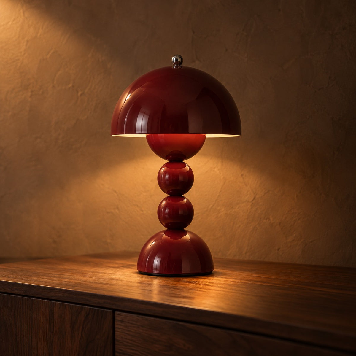Bauble mushroom table lamp in wine red on a walnut sideboard
