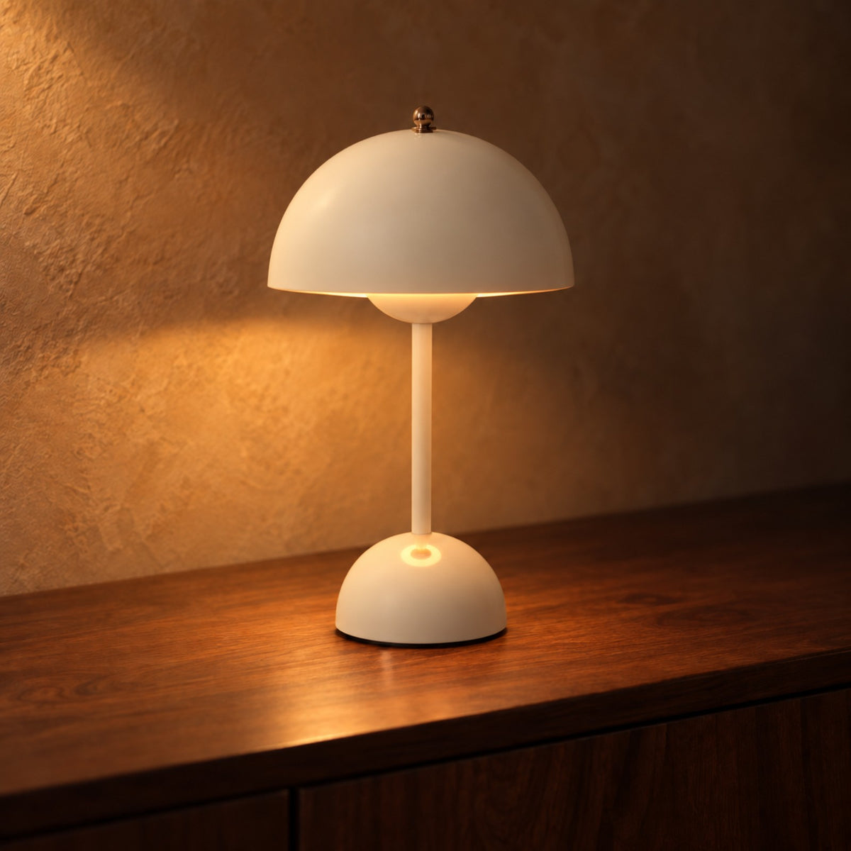 Cream bud table lamp glowing on a dark walnut sideboard