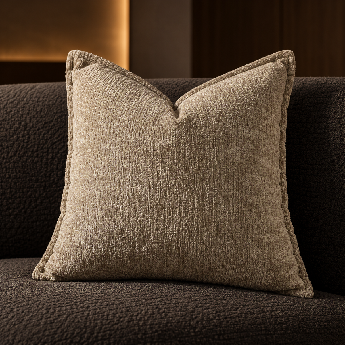 Chenille cushion in sand beige on a charcoal boucle sofa
