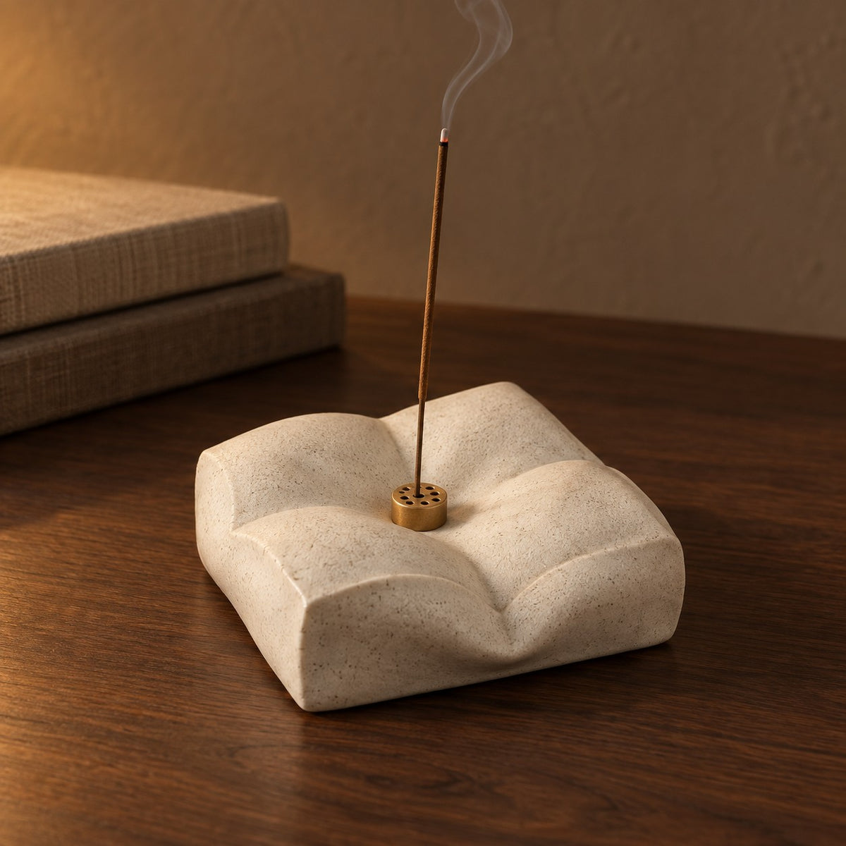 Cloud Cushion Incense Holder in sand white with a lit incense stick
