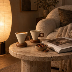 Cone cup with walnut tone wood stand in a cosy reading nook