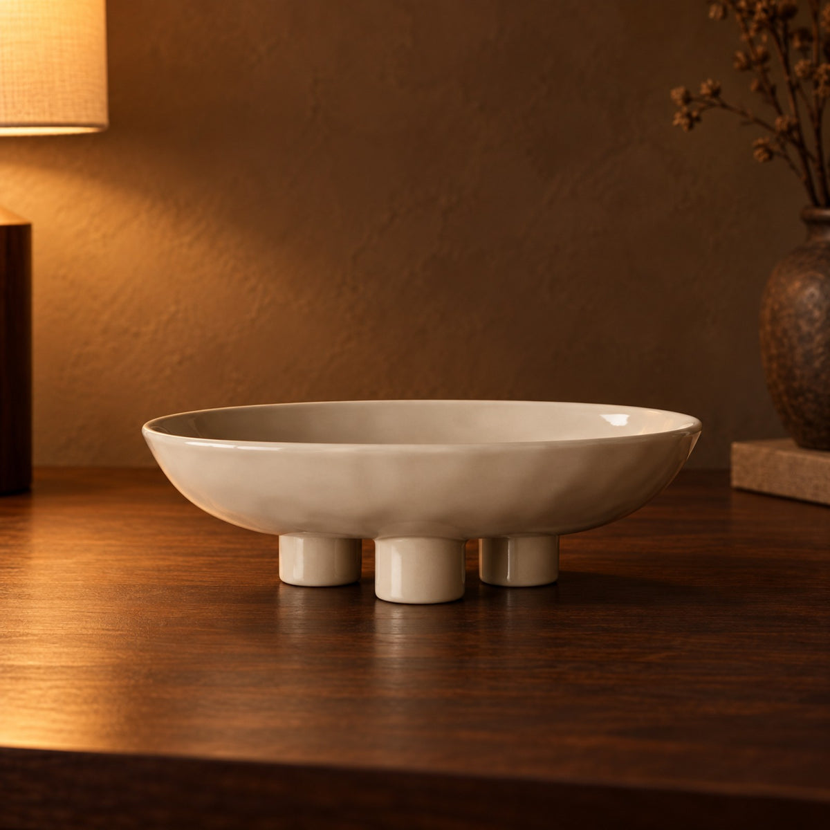 Footed Oval Ceramic Dish close up on a walnut console