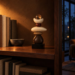 Cairn balance stones sculpture on a walnut bookshelf