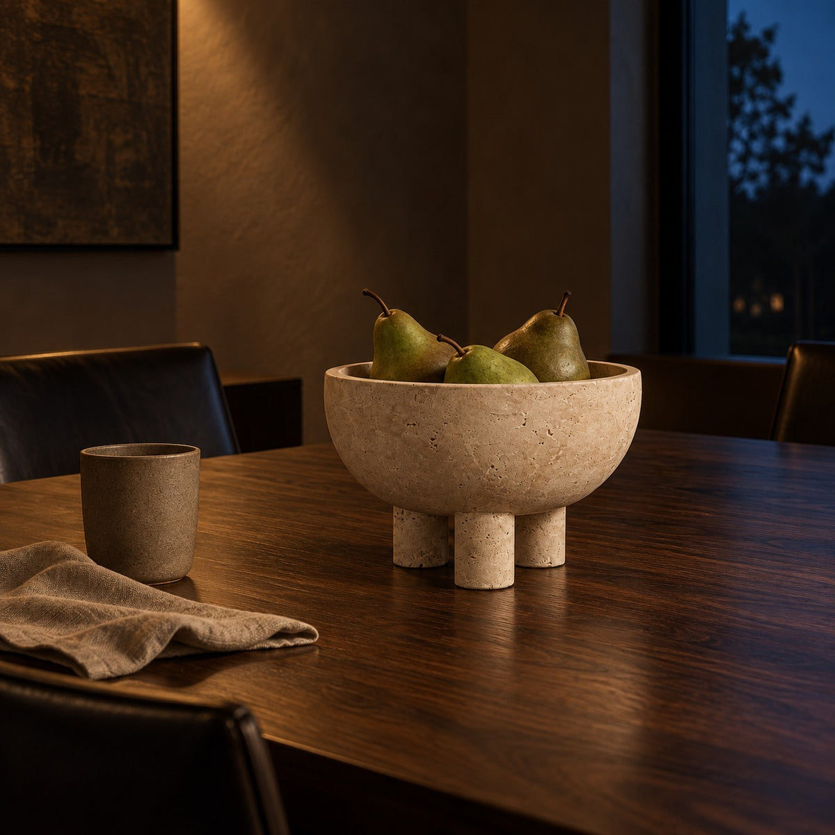 Travertine Footed Bowl lifestyle, on a walnut dining table at night