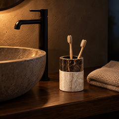 Marble bathroom cup as a toothbrush holder on a walnut vanity