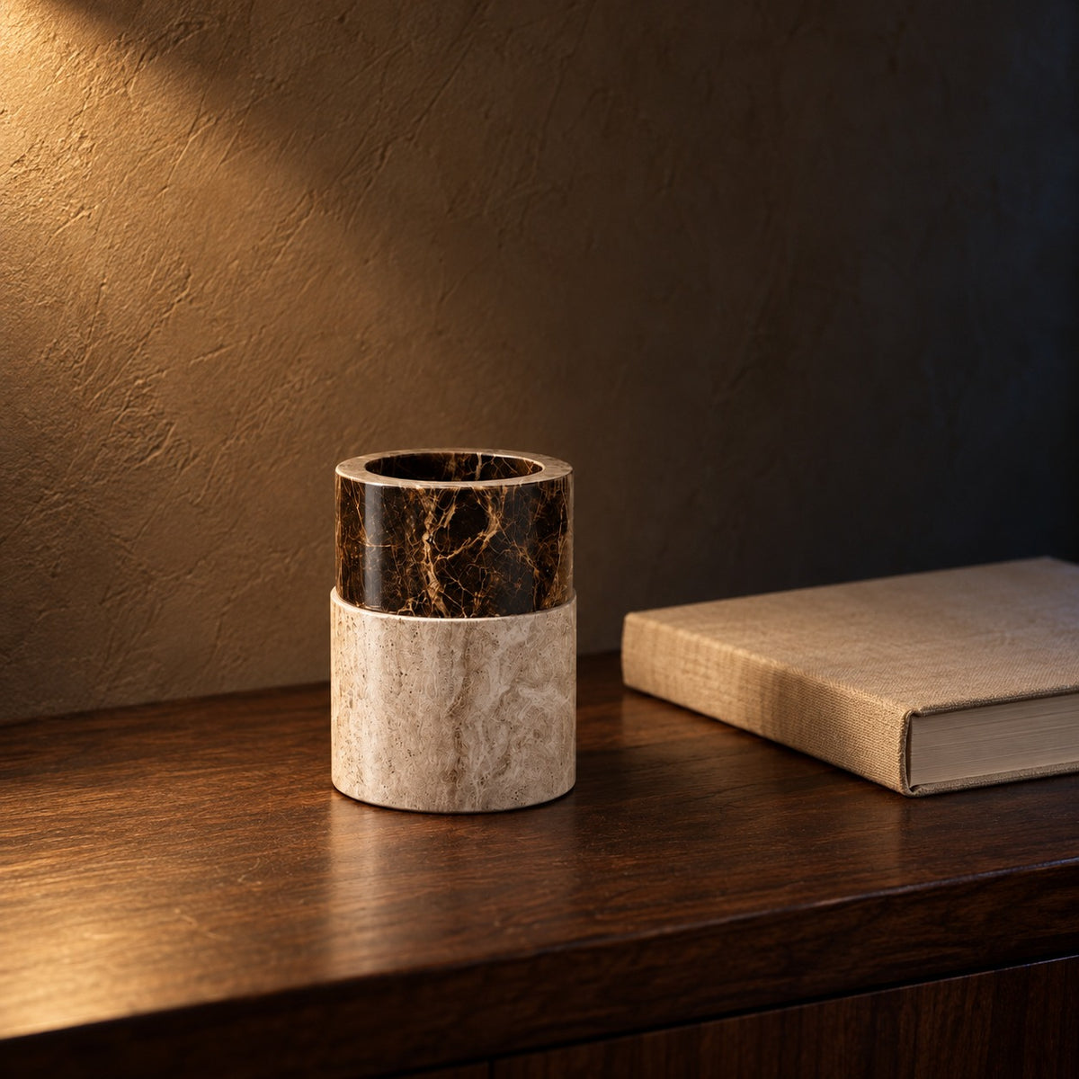 Marble bathroom cup next to a hardcover book for size