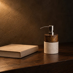 Marble soap dispenser next to a hardcover book for size