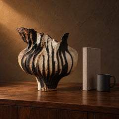 Umbra Drip Sculptural Vase beside a coffee mug and a hardcover book, showing its 34 cm height