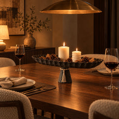 Black pedestal tray as a dining table centrepiece at night