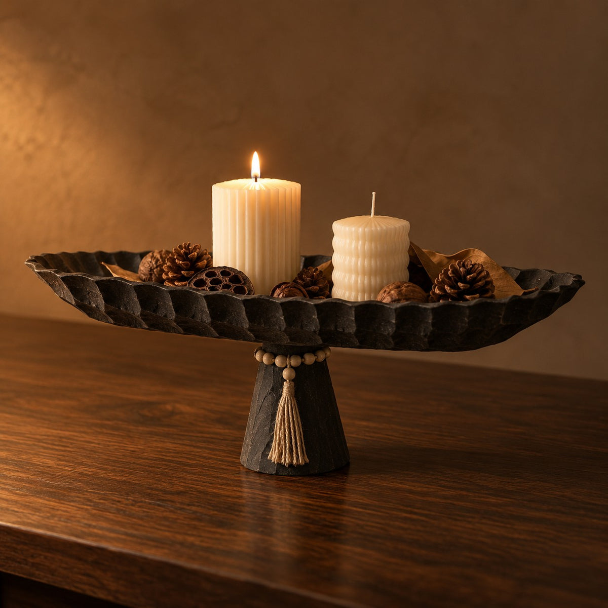 Ebony Pedestal Tray with candles and pinecones on a walnut table