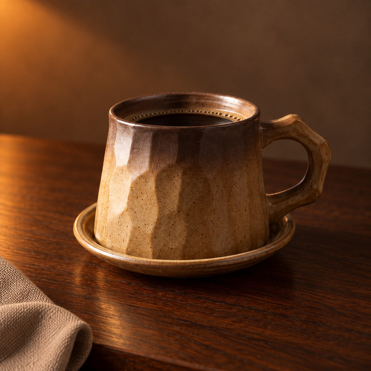 Faceted stoneware cup and saucer, Toffee