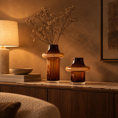 Halo Amber Glass Vases on a walnut sideboard at night