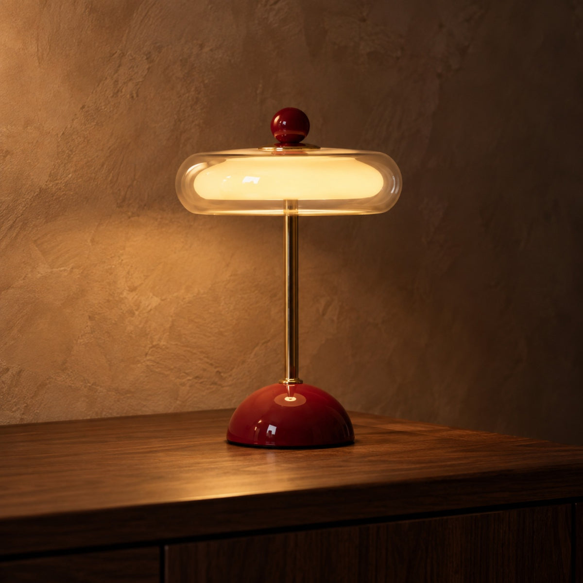 Wine red retro table lamp with cream glass disc shade on walnut