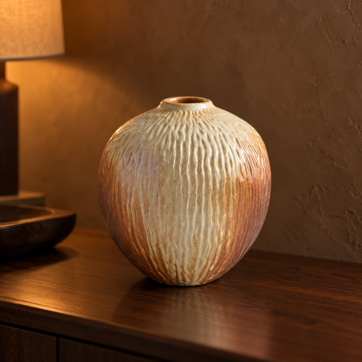 Dune Carved Ceramic Vase close up on a walnut sideboard