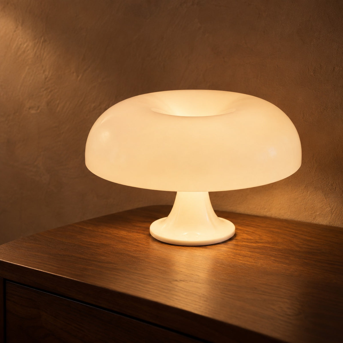 White opal cordless mushroom lamp glowing on walnut