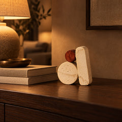 Balanced Stack Ceramic Sculpture beside linen books