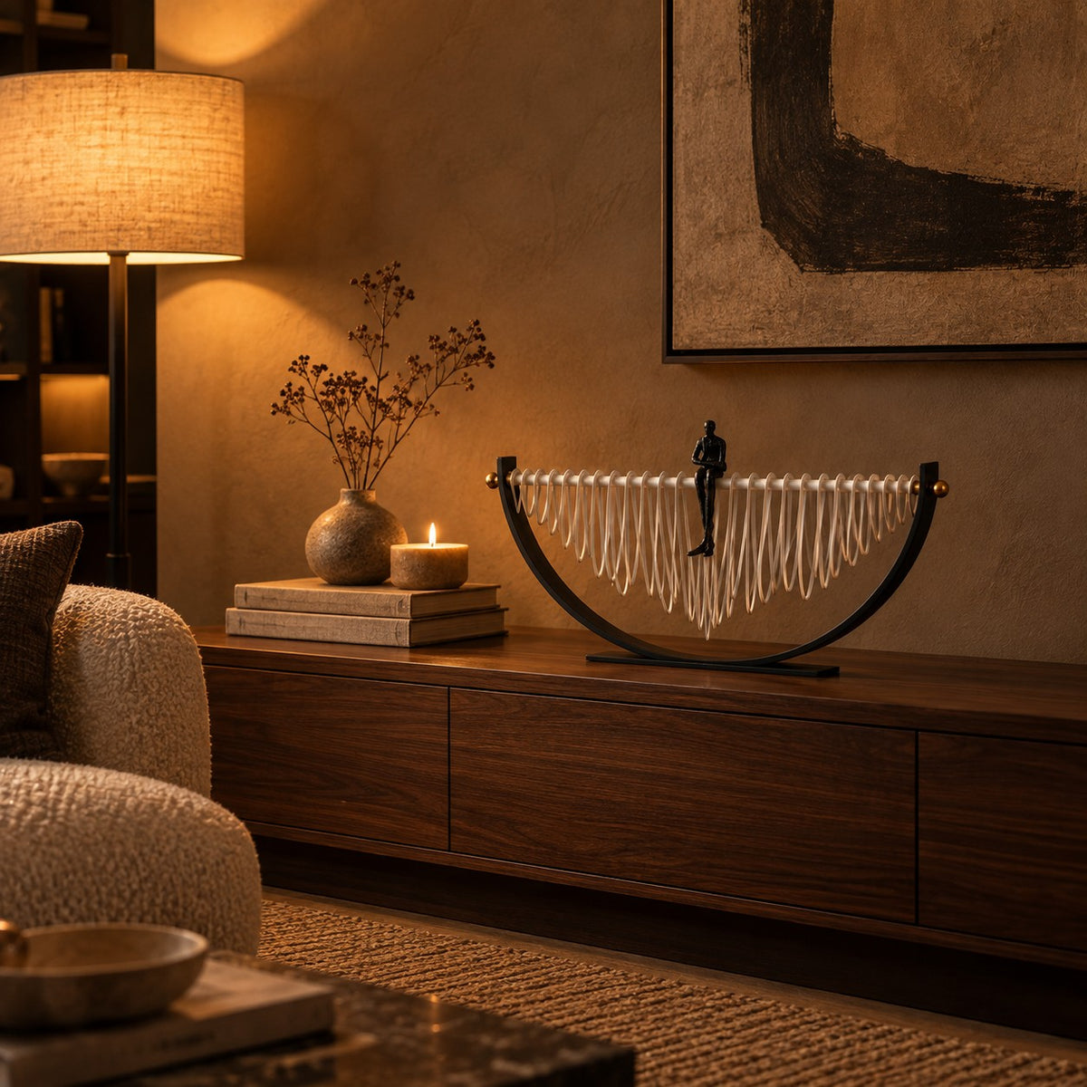 Reverie Crescent Sculpture on a walnut media console at night
