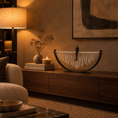 Reverie Crescent Sculpture on a walnut media console at night