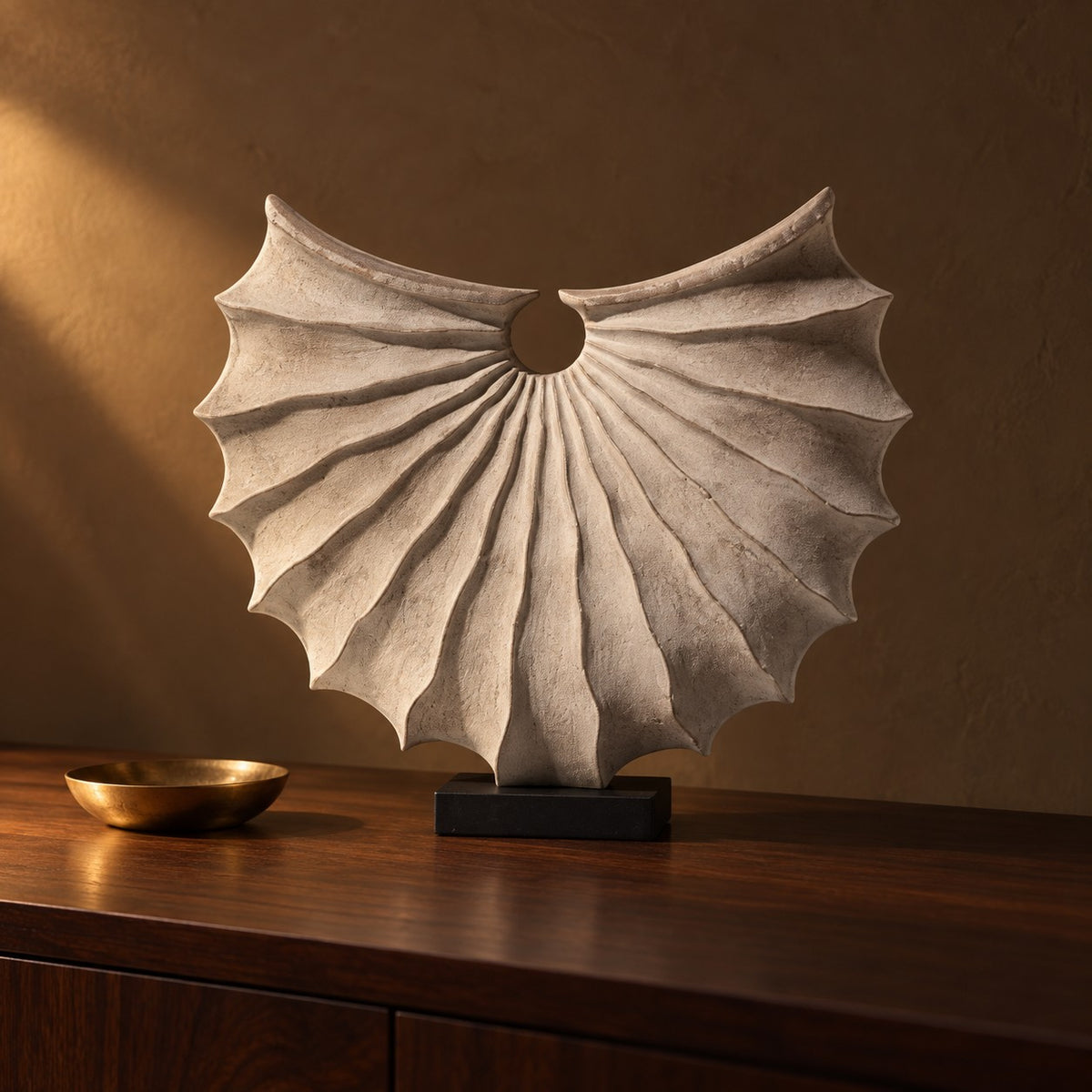 Nautilus Fan Sculpture in stone grey resin on a dark walnut console with a brass dish