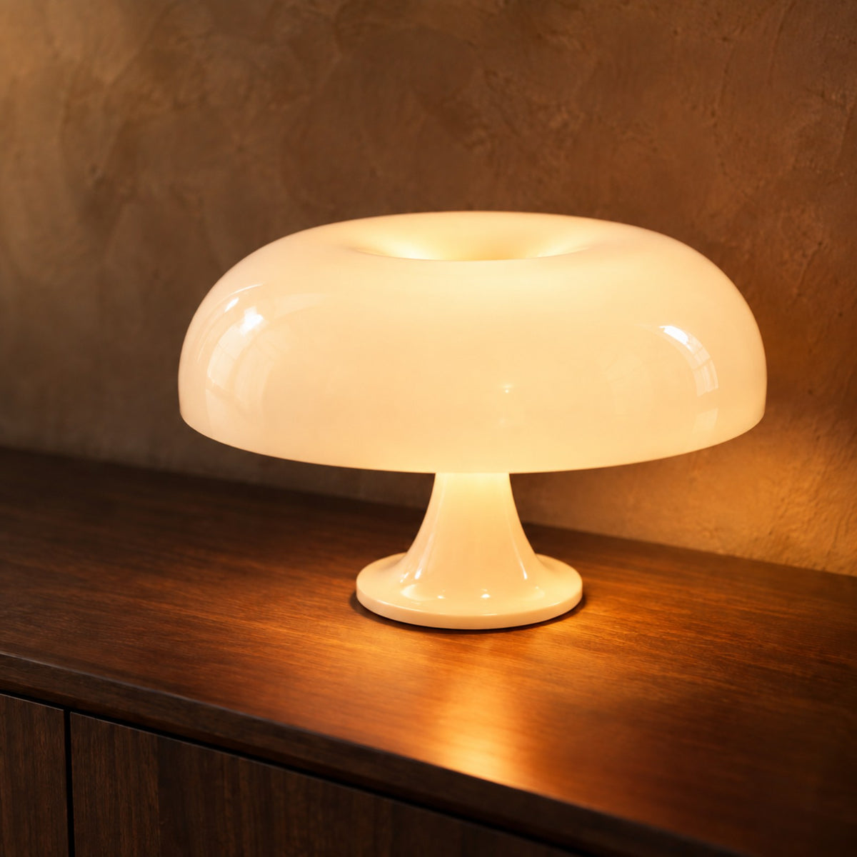 Cream mushroom table lamp glowing on a dark walnut sideboard