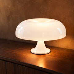 White mushroom table lamp on a dark walnut sideboard