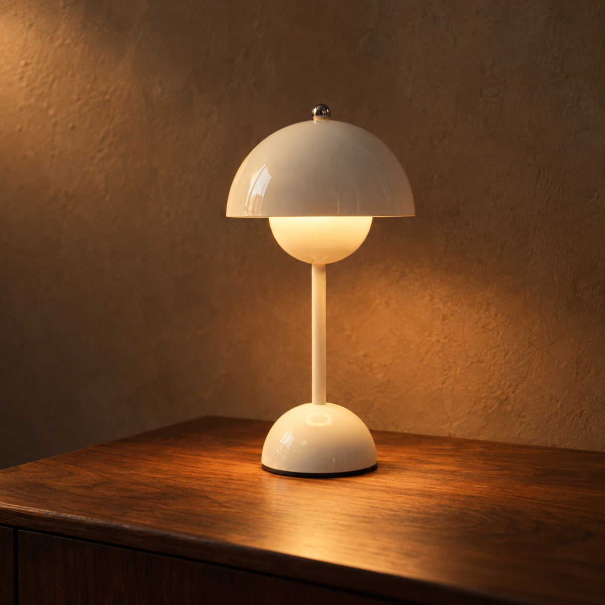 White rechargeable bud night lamp on a walnut bedside table