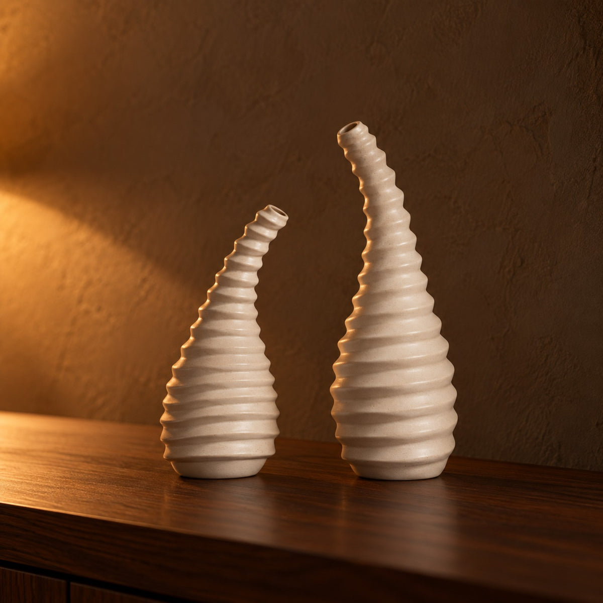 Spiral ribbed sand beige ceramic vase pair on a walnut shelf