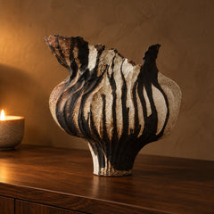 Umbra Drip Sculptural Vase on a walnut sideboard